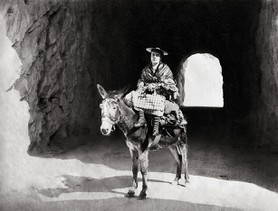 Photos de la Riviera par Jean Gilletta. - Étude artistique. Bouquetière niçoise sur un âne, basse corniche entre Beaulieu et Èze, vers 1890.